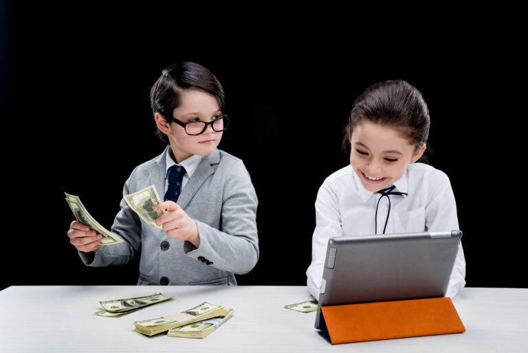 kids playing business people with money and laptop  isolated on black